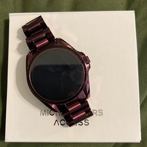 Hardly used plum Michael Kors smartwatch. Includes links, charger, box & guides.